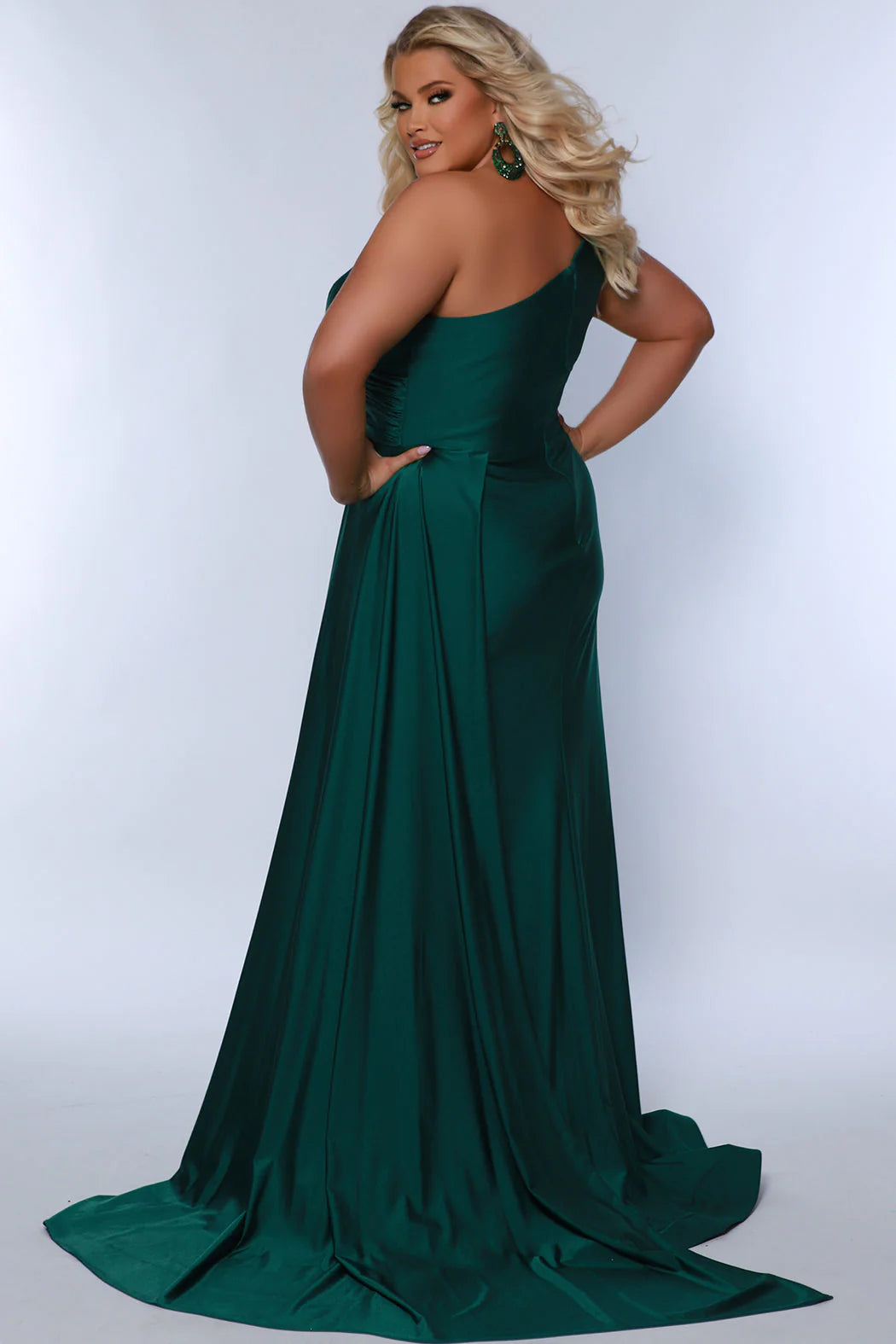 Experience elegance and glamour in the SC7377 gown from Sydneys Closet. This A-line over skirt dress features a one shoulder strap, perfect for your next special event or formal occasion. The full train adds a beautiful and regal finish to the look. Plus size available for up to size 24. Get ready to be the woman who turns heads at Prom 2024 or any special occasion evening event in the Simple and Sophisticated formal dress designed by Sydney's Closet.