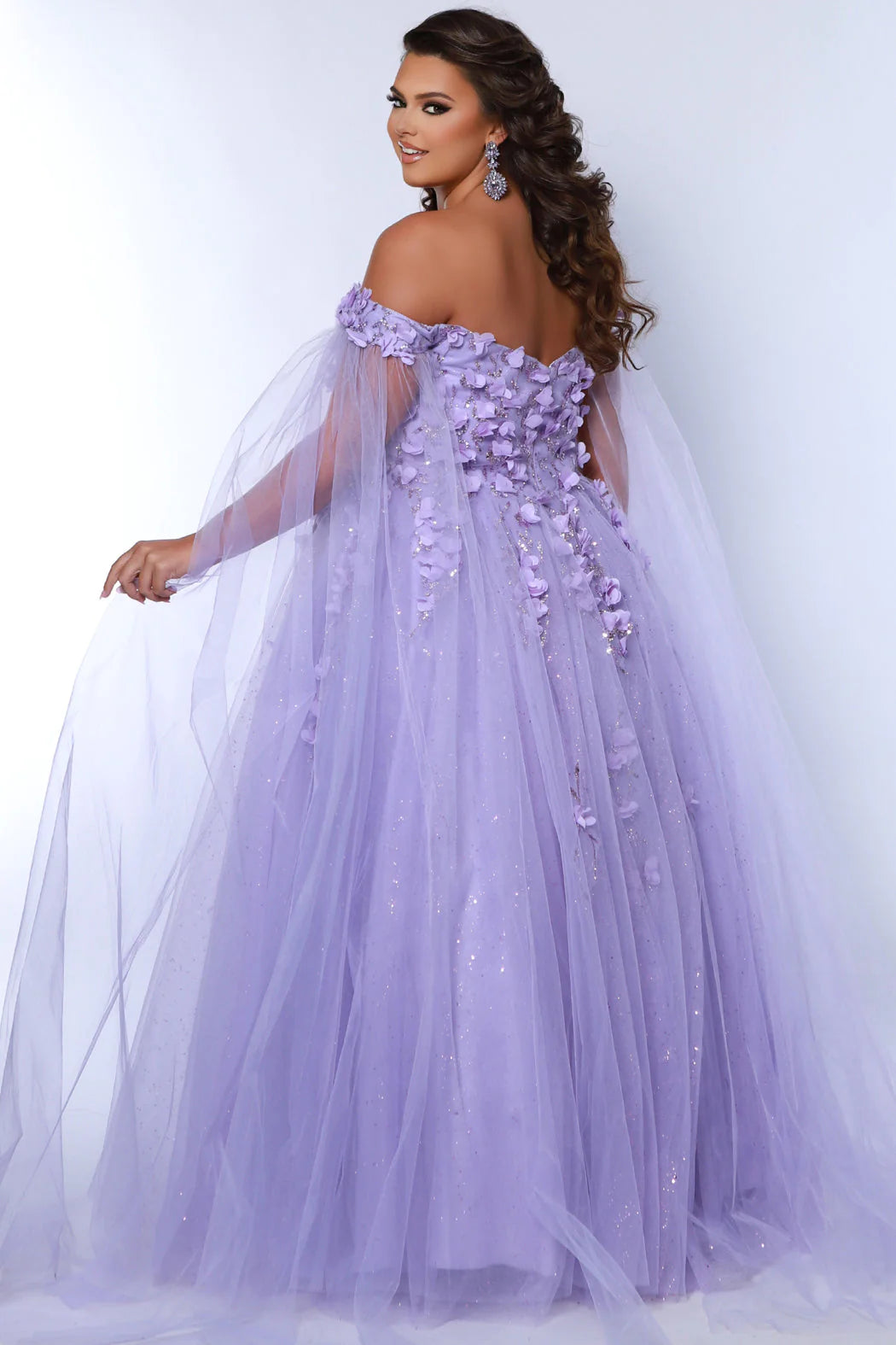 This glamorous Sydneys Closets SC7379 prom dress features an off-shoulder, sweetheart neckline and a fitted silhouette adorned with 3D floral details. The elegant design is perfect for a formal occasion such as a prom, pageant, or wedding. Plus size options are available for an ideal fit. Look and feel  like royalty at Prom 2024 or any formal ball when you opt to be lady who wears our "Dream On" gown.