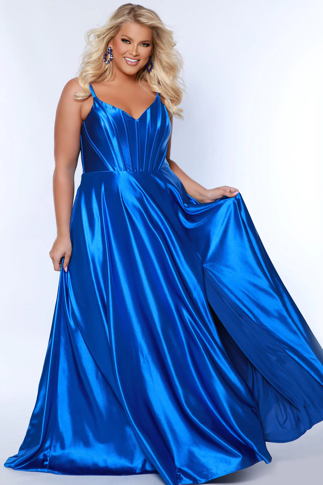 This elegant Sydneys Closet SC7380 Long Prom Dress is designed with a Plus Size V Neck silhouette, crafted from luxurious Satin. Featuring an A-Line corset bodice and long floor length skirt, this timeless Formal Gown is perfect for any special event or pageant. You're both gorgeous and glamorous when you wear this "Sweet in Satin" long formal gown to Prom 2024 or your next fancy evening event. 