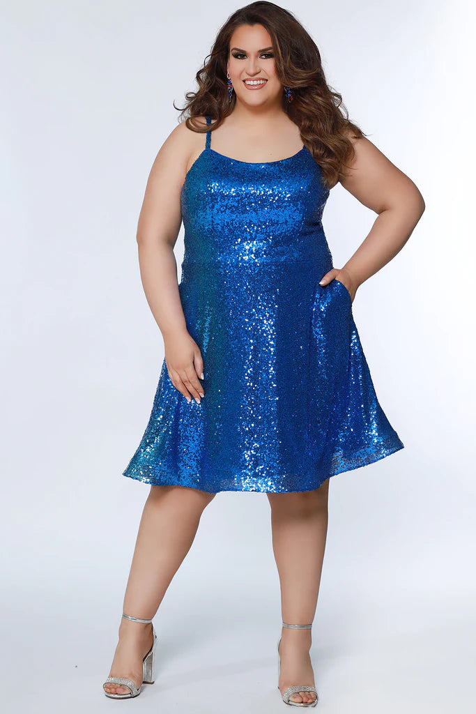 Sydney's Closet SC8122 A-Line Multi-Dimensional Sequins Scoop Neck With Pockets Short Plus Size Homecoming Dress. Make your homecoming night unforgettable with this plus size showstopper! Sydney's Closet SC8122 dress features a dazzling multi-dimensional sequin exterior, scoop neckline, and front pockets to keep your dancing essentials close at hand. A glam-slam pick that will leave you feeling your 'prom