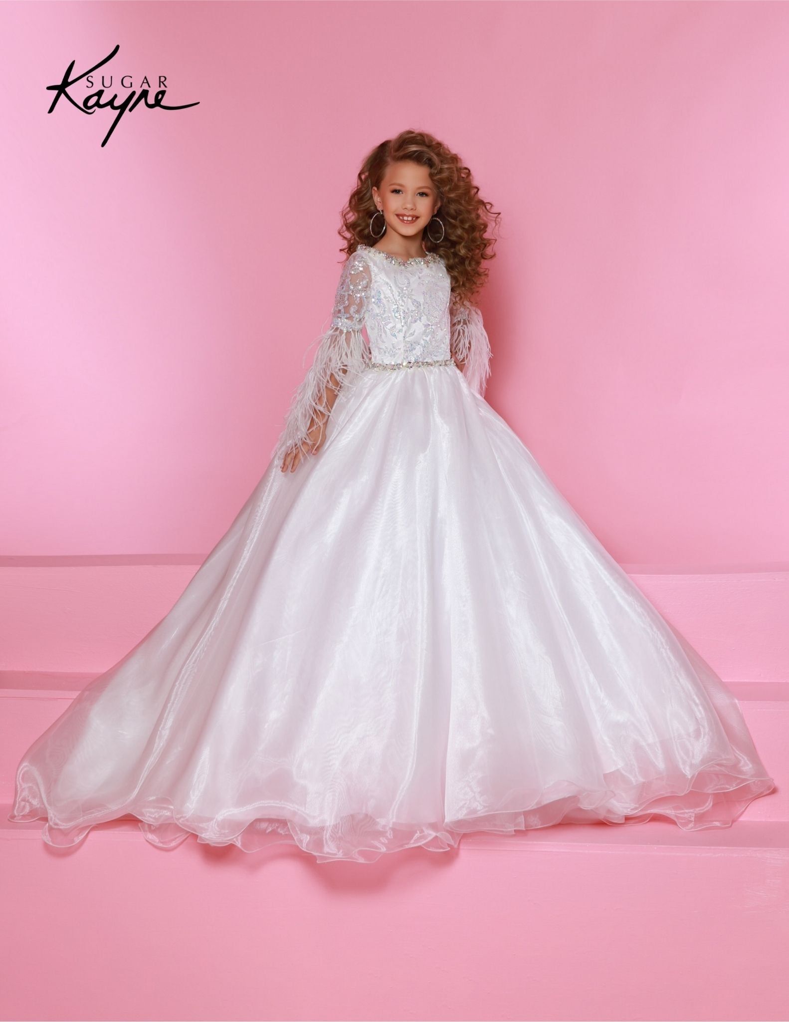 The Sugar Kayne C338 Preteen Pageant Dress is an elegant A-line ballgown featuring sequin and feather sleeves. Featuring the highest quality materials, this dress is perfect for special occasions and is sure to make your child feel like a princess. Experience twinkling elegance in this Metallic Organza Ballgown. The feathered sleeves are designed to make you feel like royalty.