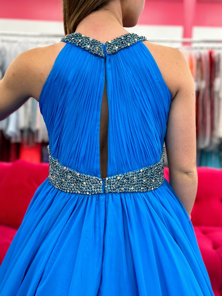 Samantha Blake 1102 Girls Pageant Dress. This stunning A Line Chiffon gown, complete with a detachable crystal Embellished cape and chiffon material, will make any young girl feel like a princess. With its train design, it offers elegance and grace for any special occasion. Get yours today and make a statement at your next Pageant.