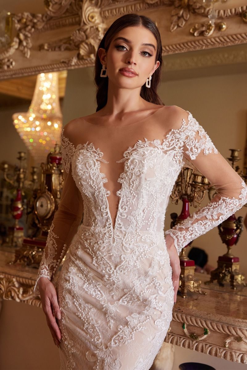 This gorgeous long sleeve lace wedding gown showcases beautiful lace work through out the body. Classic from front and sexy from back with a heart-shaped opening, this gown truly is designed to make a bride feel beautiful. The lace at sleeve grazes the knuckle for the ultimate ring-closeup shot. Luxurious lace scalloped hem is elongated at back to creates a breathtaking mermaid silhouette.