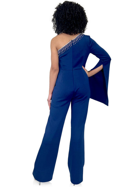 Enhance your evening look with Marc Defang's 8267 Pageant Jumpsuit. This elegant design features a one-shoulder neckline, One long bell sleeves, a crystal fringe detail and a fitted silhouette. Update your wardrobe with this fashionable and flattering piece.  Sizes: 00-16  Colors: Hot Pink, Royal Blue, Neon Green, Light Blue, Black  Contact us for custom colors - Allow 30 days Production