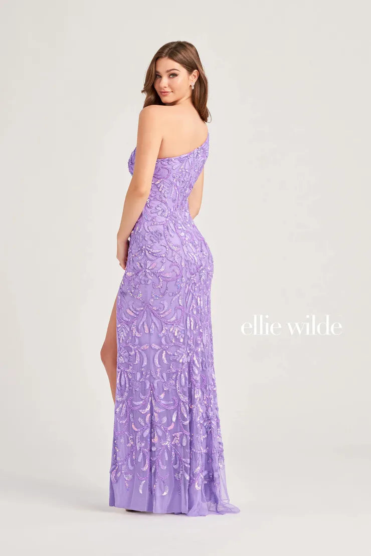 Expertly crafted by Ellie Wilde EW35021, this one shoulder prom dress is sure to make a statement. The intricate beaded and sequin detailing adds just the right amount of sparkle, while the slit provides a touch of elegance. Perfect for any formal occasion, this gown is designed to stand out.  Sizes: 00-16  Colors: Lavender, Red, Royal Blue