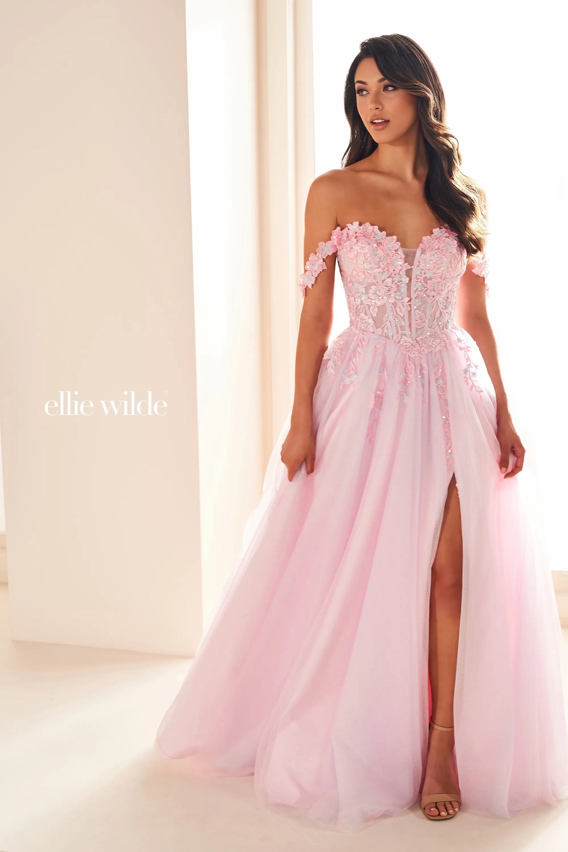 Indulge in luxury and elegance with the Ellie Wilde EW36214 Prom Dress. This long maxi gown boasts a sheer lace corset that cinches your waist and an off-the-shoulder neckline for a touch of allure. The thigh-high slit adds a sultry touch to this formal gown, perfect for making a statement at any event.