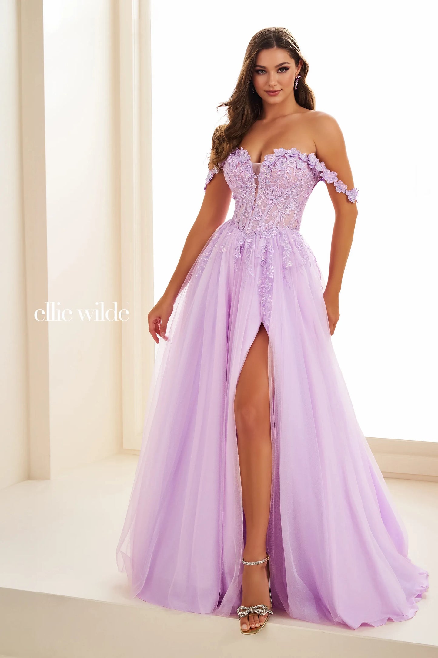 Indulge in luxury and elegance with the Ellie Wilde EW36214 Prom Dress. This long maxi gown boasts a sheer lace corset that cinches your waist and an off-the-shoulder neckline for a touch of allure. The thigh-high slit adds a sultry touch to this formal gown, perfect for making a statement at any event.