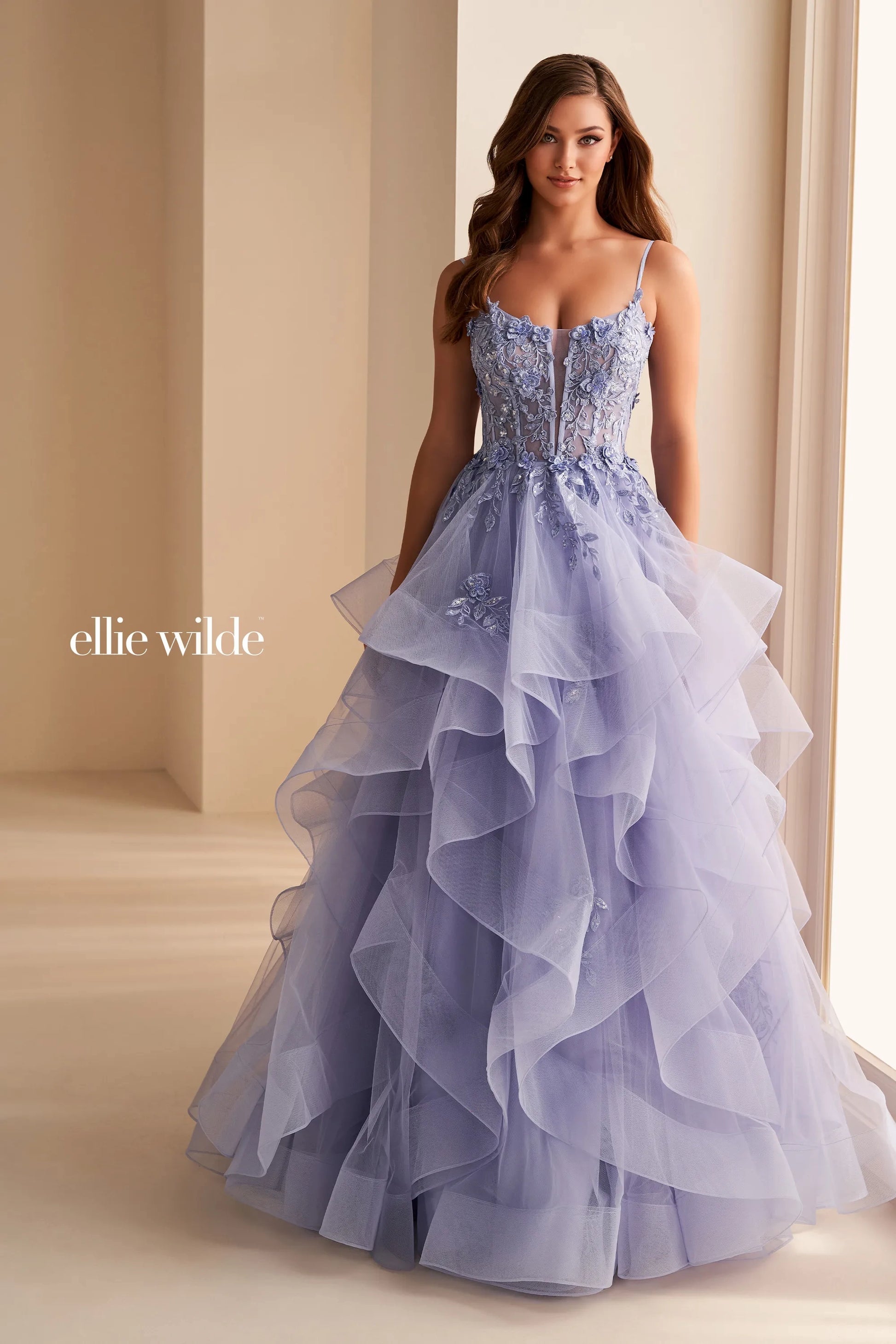 Step into elegance with the Ellie Wilde EW36225 Sheer Lace Corset Ball Gown. Featuring a stunning sheer lace bodice and layered corset, this formal evening gown is perfect for prom or any special occasion. Make a statement in this luxurious and exclusive dress, designed to make you feel like a work of art.