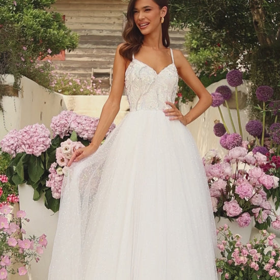 This Amarra 94020 spectacular tulle prom gown with a sweetheart neckline and beaded crystals will have you feeling like a princess for the night. Its color - white - is dazzling, and sparkles even more in the light of the beaded crystals that decorates the shimmering tulle skirt. Above the skirt, is the beautiful bodice designed delicately with sequins with sparse coloring of light blue, yellow and brown. 