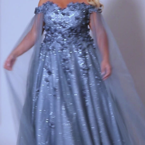 This glamorous Sydneys Closets SC7379 prom dress features an off-shoulder, sweetheart neckline and a fitted silhouette adorned with 3D floral details. The elegant design is perfect for a formal occasion such as a prom, pageant, or wedding. Plus size options are available for an ideal fit. Look and feel  like royalty at Prom 2024 or any formal ball when you opt to be lady who wears our "Dream On" gown.