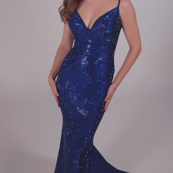 Look stunning in the Ellie Wilde EW35002 prom dress! Crafted from luxurious crystal jersey fabric, this mermaid evening gown features a corset-style bodice and a snug fit for a captivating silhouette. Decorated with shimmering Crystal accents, this dress adds sparkle and shine for an unforgettable formal look.  COLOR: BLACK, NAVY BLUE, ROYAL BLUE, TEAL, HOT PINK, RUBY, ORCHID SIZE: 00 - 24