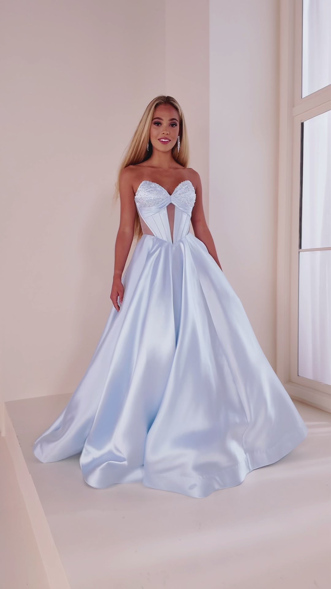 This Ellie Wilde EW36025 prom dress features a stunning A-line silhouette with sheer ballgown detailing and a corset back for a perfect fit. The dress also includes convenient pockets and cut-out design, making it both fashionable and functional for any pageant or formal event.