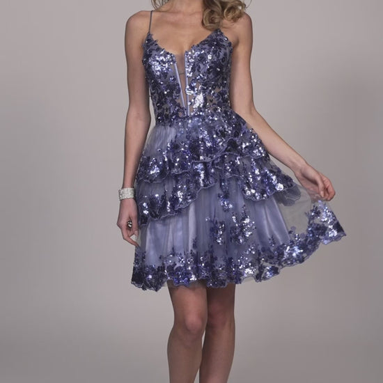 Experience glamor and style in the Dave &amp; Johnny 11961 Asymmetrical Ruffle Sequin Homecoming Dress. With a sheer corset and asymmetrical ruffle detailing, this cocktail gown is sure to turn heads. The sequin embellishments add a touch of sparkle to this elegant dress, perfect for any special occasion.