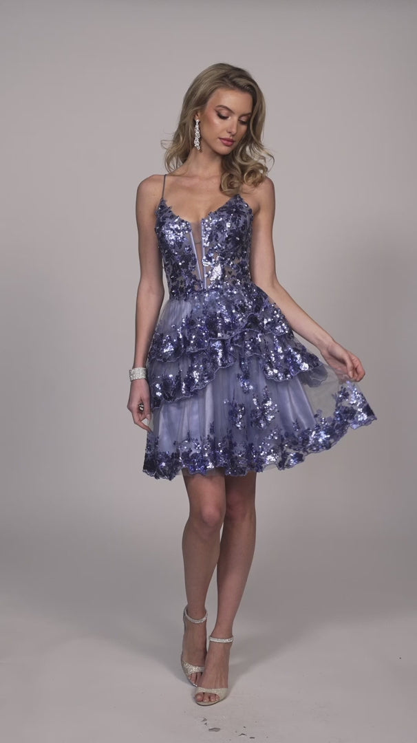 Experience glamor and style in the Dave &amp; Johnny 11961 Asymmetrical Ruffle Sequin Homecoming Dress. With a sheer corset and asymmetrical ruffle detailing, this cocktail gown is sure to turn heads. The sequin embellishments add a touch of sparkle to this elegant dress, perfect for any special occasion.