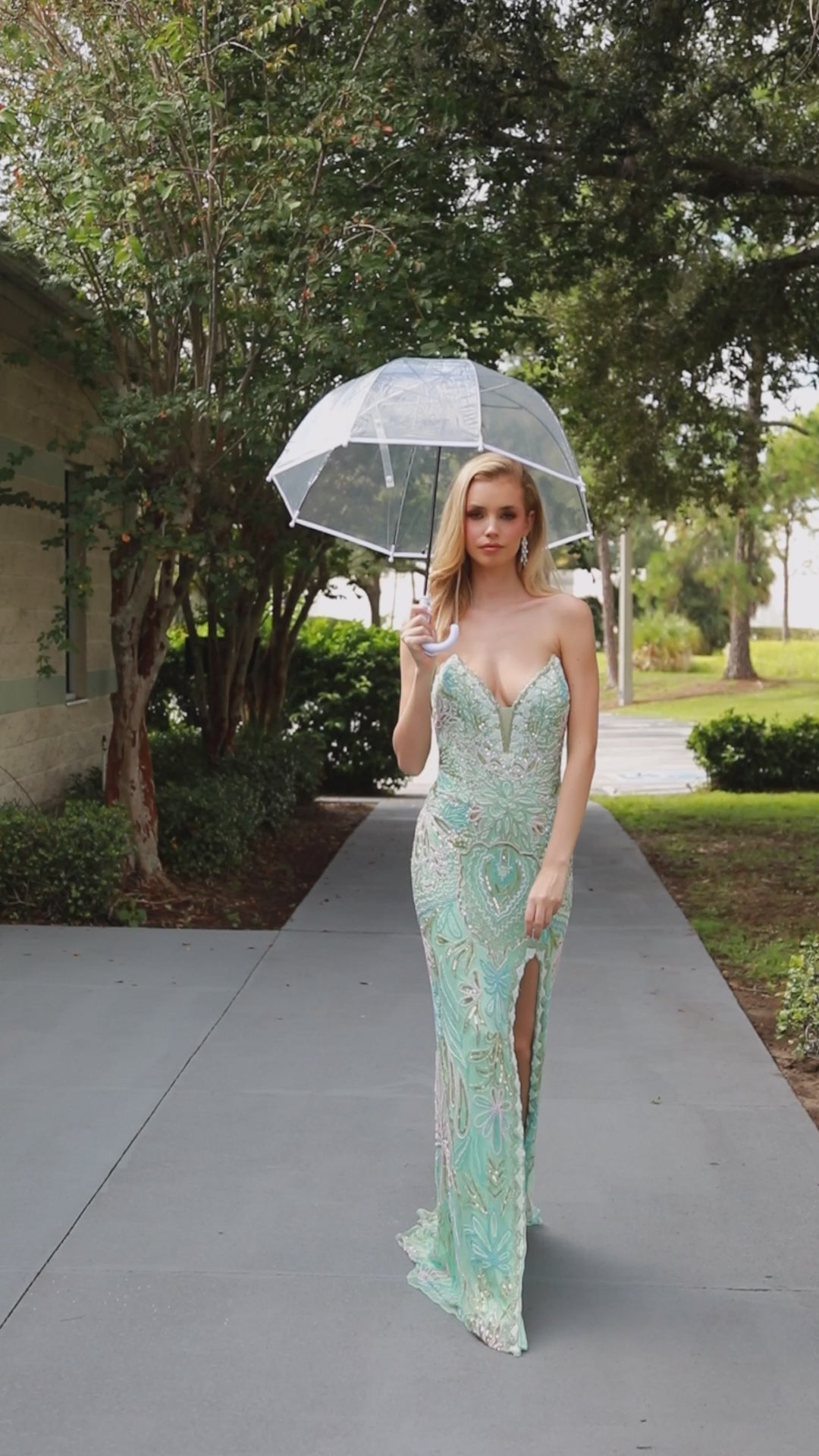 This Primavera Couture 4382 dress exudes elegance with its long beaded strapless corset, slit V-neck design, and formal evening gown style. Perfect for prom or any special occasion, it offers a flattering silhouette and stunning details. Elevate your look with this exquisite dress.