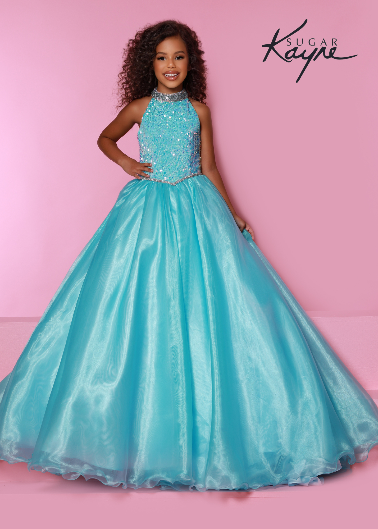 Sugar Kayne C302 sequin stretch velvet and organza ballgown features a stunning beaded halter with dropped waist and rhinestone trim and beaded strap back  Available Sizes: 2-16  Available colors: Aqua, Cotton candy, Orchid, Powder Blue