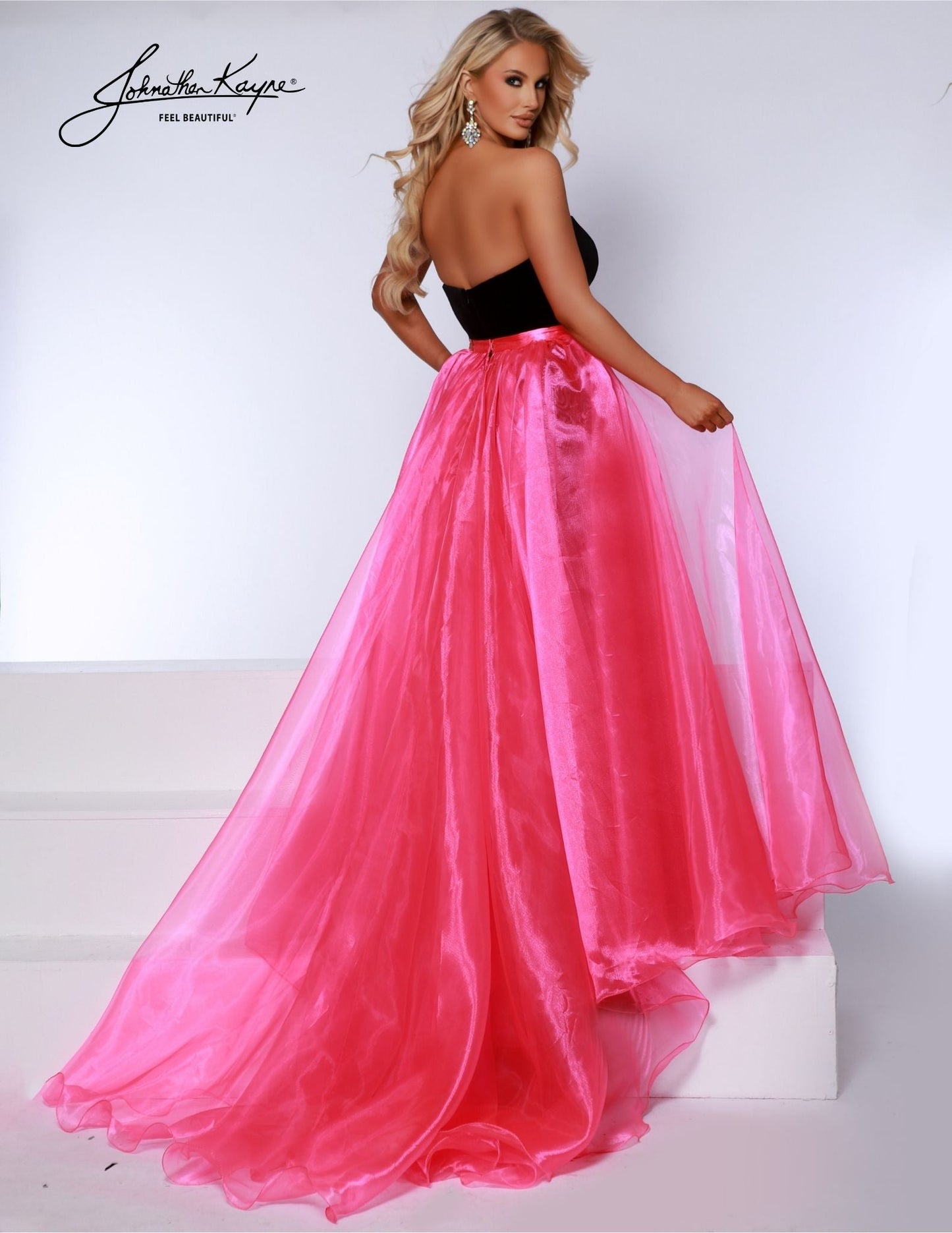 Experience the versatility of the Johnathan Kayne Detachable Overskirt. Designed with organza fabric and a wire hem, this formal wear accessory adds a touch of glamour to any pageant or special event. Transform your look with the detachable feature and elevate your style game. A true wardrobe essential, this poly organza overskirt allows you to personalize your look for various occasions. Whether paired with a gown, a cocktail dress, or even a casual ensemble, it adds an instant dose of elegance and flair.