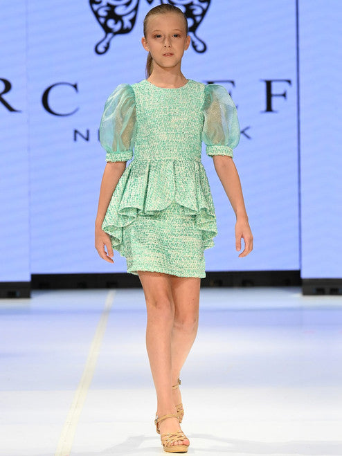 Marc Defang's 5141 short tweed dress offers a stylish and professional look for your daughter's special occasions. This formal dress features and eye-catching puff sleeves and a playful ruffle skirt, while the tweed fabric ensures durability. Perfect for a pageant or an interview, this dress is sure to make a memorable impression.  Sizes: 4-14  Colors: Lemon, Mint, Blush, Light Blue