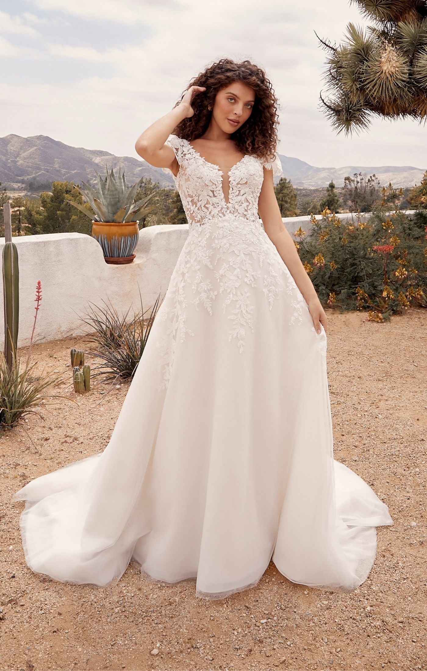 Casablanca Beloved BL435Rusty A-Line Low Back Cap Sleeves V-Neck 3D Appliques Floral Embroidered Train Wedding Gown. Embodying all things romance, Rusty is for the bride who wants to feel like she’s floating on cloud nine. Her A line shape with layers of organza, beaded floral lace and luxurious lining make this dress so divine to wear. 