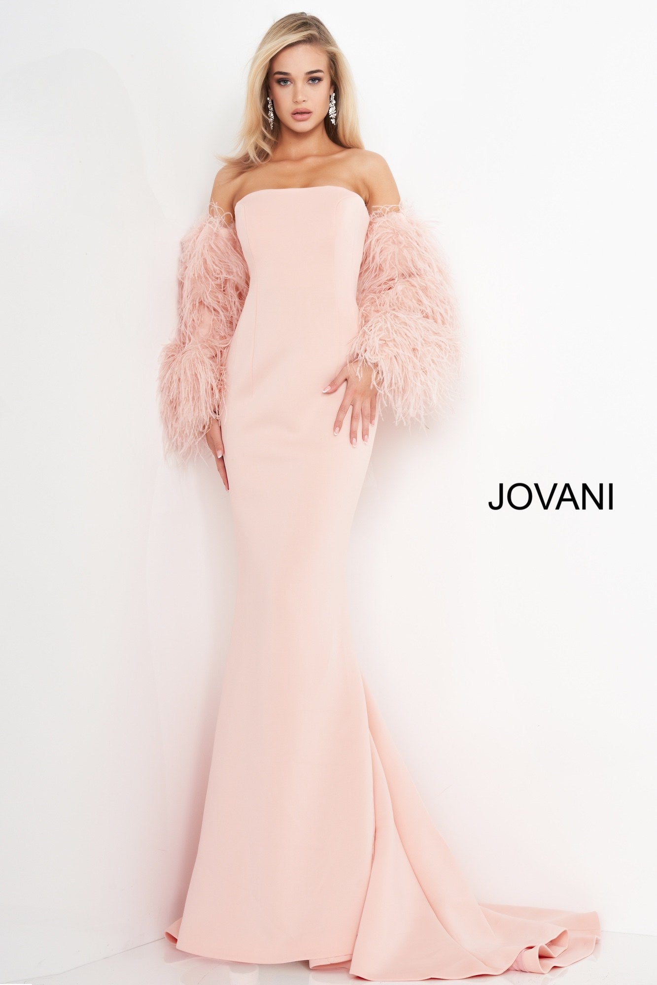 Jovani 1226 is a Long Fitted Mermaid Scuba Formal Evening Gown. This Straight neckline with Long Off the Shoulder Feather Sleeves. This Fit & Flare Wedding Dress Features a Lush Sweeping train. Great Red Carpet or formal event gown. Great for a wedding guest dress or mother of the bride gown. Stretch scuba fabric, form fitting silhouette, floor length with train, strapless bodice, straight neckline, ostrich feather sleeves. Available Sizes: 00-24  Available Colors: black, blush, white, white/black