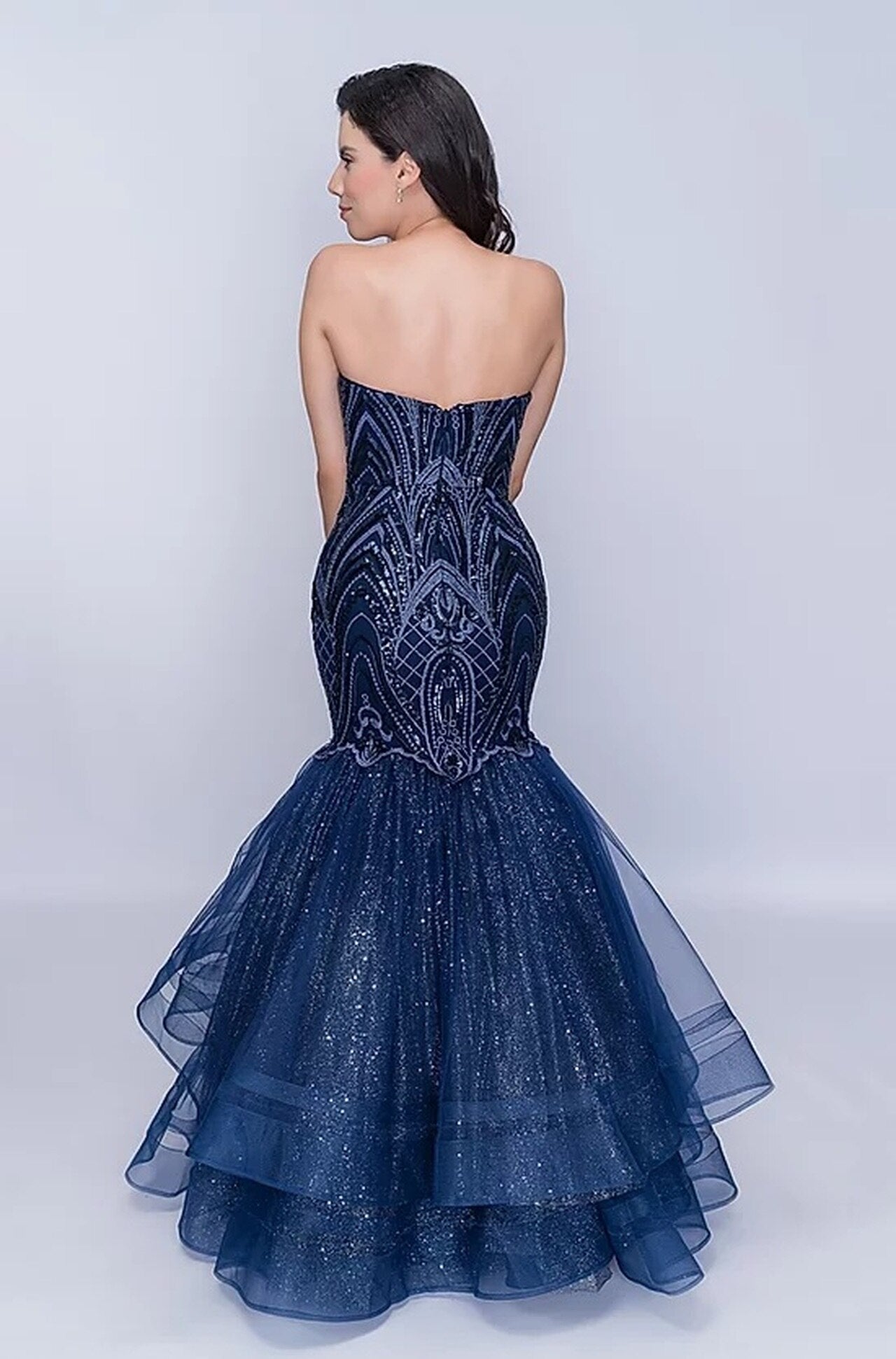 Nina Canacci 1407 is a long fitted mermaid prom dress. strapless sweetheart neckline with a fitted embroidered lace embellished bodice. trumpet flared mermaid skirt features layers of glitter tulle ruffled with double horse hair traim.  Available Size: 4  Available Color: Navy