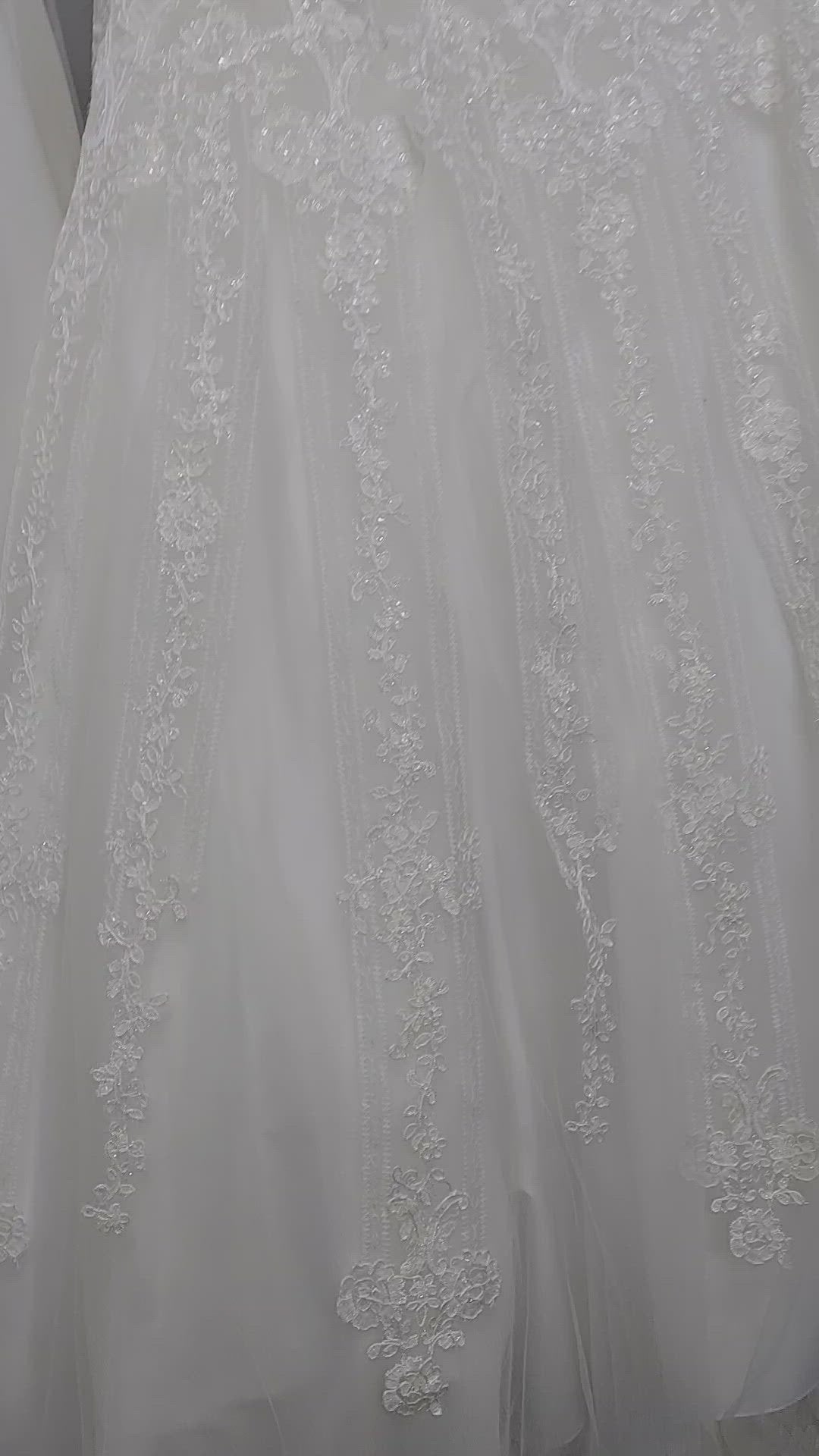 Nina Canacci 1508 is a long Lace Embellished Ivory wedding Dress. Featuring a scallop edge lace fitted bodice with adjustable spaghetti straps. Cascading floral embroidered lace flowing into the full a line ballgown skirt. Great Plus Size Bridal & Destination wedding dress. Sequin Embellished A Line Ballgown.   Available Sizes: 8  Available Colors: Diamond White