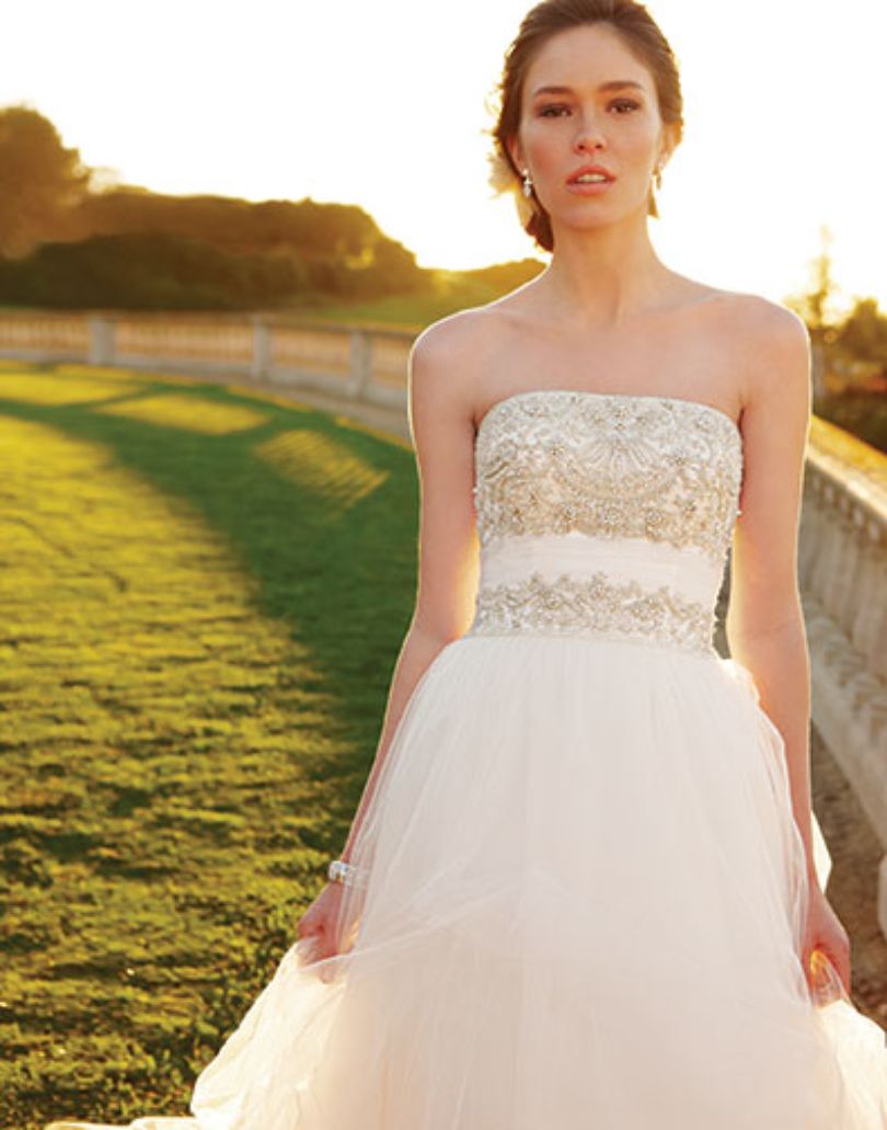 Casablanca Bridal 2052 Soft Tulle pick-ups over Silky Satin accented with heavily beaded bodice and a ruched Tulle waistband this wedding dress is over the top romantic.   Color:  Ivory/Ivory/Silver  Fabric: Tulle over Silky Satin with Beaded and Embroidered bodice.  This is a size 6 in Ivory & Silver