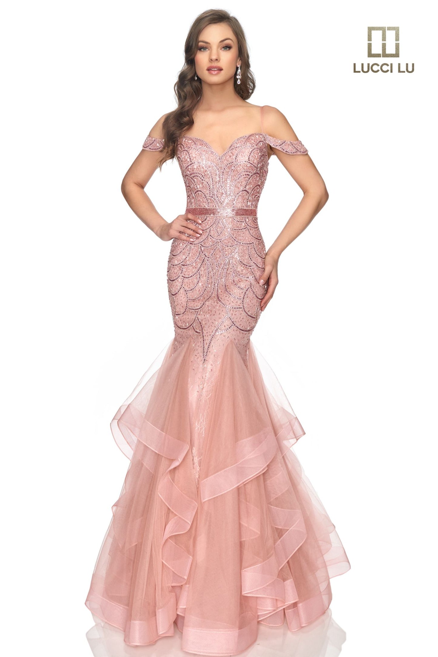 This classic Lucci Lu prom gown encapsulates sophistication and elegance with its beaded sequin-encrusted mermaid silhouette and cascading multi-layered ruffle skirt. Offering a secure fit with a secure off-the-shoulder neckline, 2147 is the perfect choice for luxurious evening events. Liquid beaded waist v neckline  Sizes:  0-16  Colors: Champagne, Dusty Blue, Dusty Rose, Gunmetal, Platinum/Gunmetal, Rose Gold