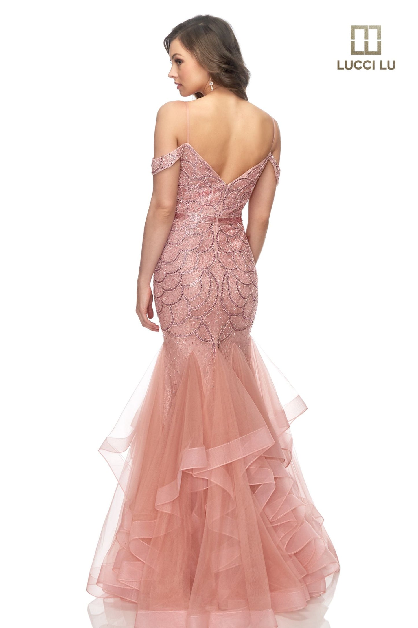 This classic Lucci Lu prom gown encapsulates sophistication and elegance with its beaded sequin-encrusted mermaid silhouette and cascading multi-layered ruffle skirt. Offering a secure fit with a secure off-the-shoulder neckline, 2147 is the perfect choice for luxurious evening events. Liquid beaded waist v neckline  Sizes:  0-16  Colors: Champagne, Dusty Blue, Dusty Rose, Gunmetal, Platinum/Gunmetal, Rose Gold