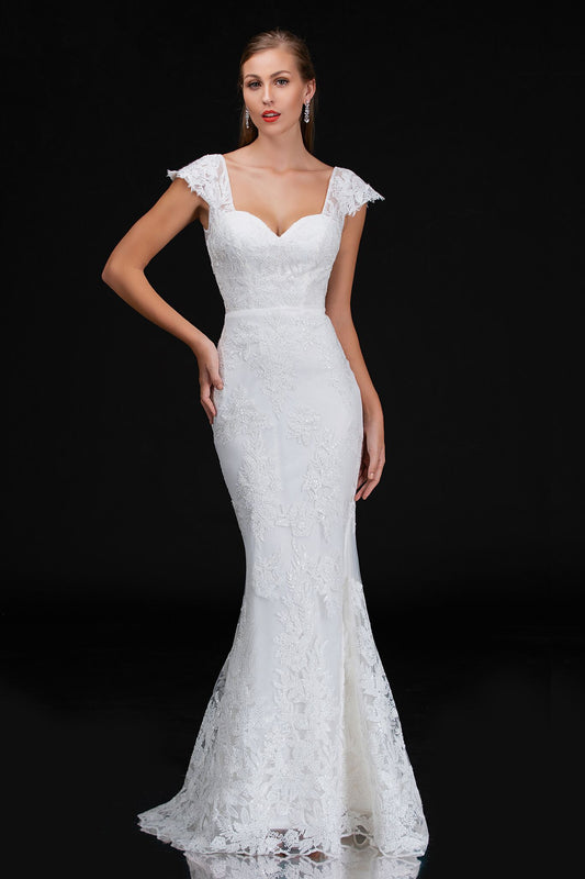 Nina Canacci 4203 is a long fitted embellished lace mermaid wedding dress. featuring a sweetheart neckline with cap sleeves with eyelash lace and a sheer lace back. Great destination bridal gown. Great for Plus Size. Mermaid fit & Flare Silhouette with a trumpet skirt  Available Sizes: 18  Available Colors: Ivory