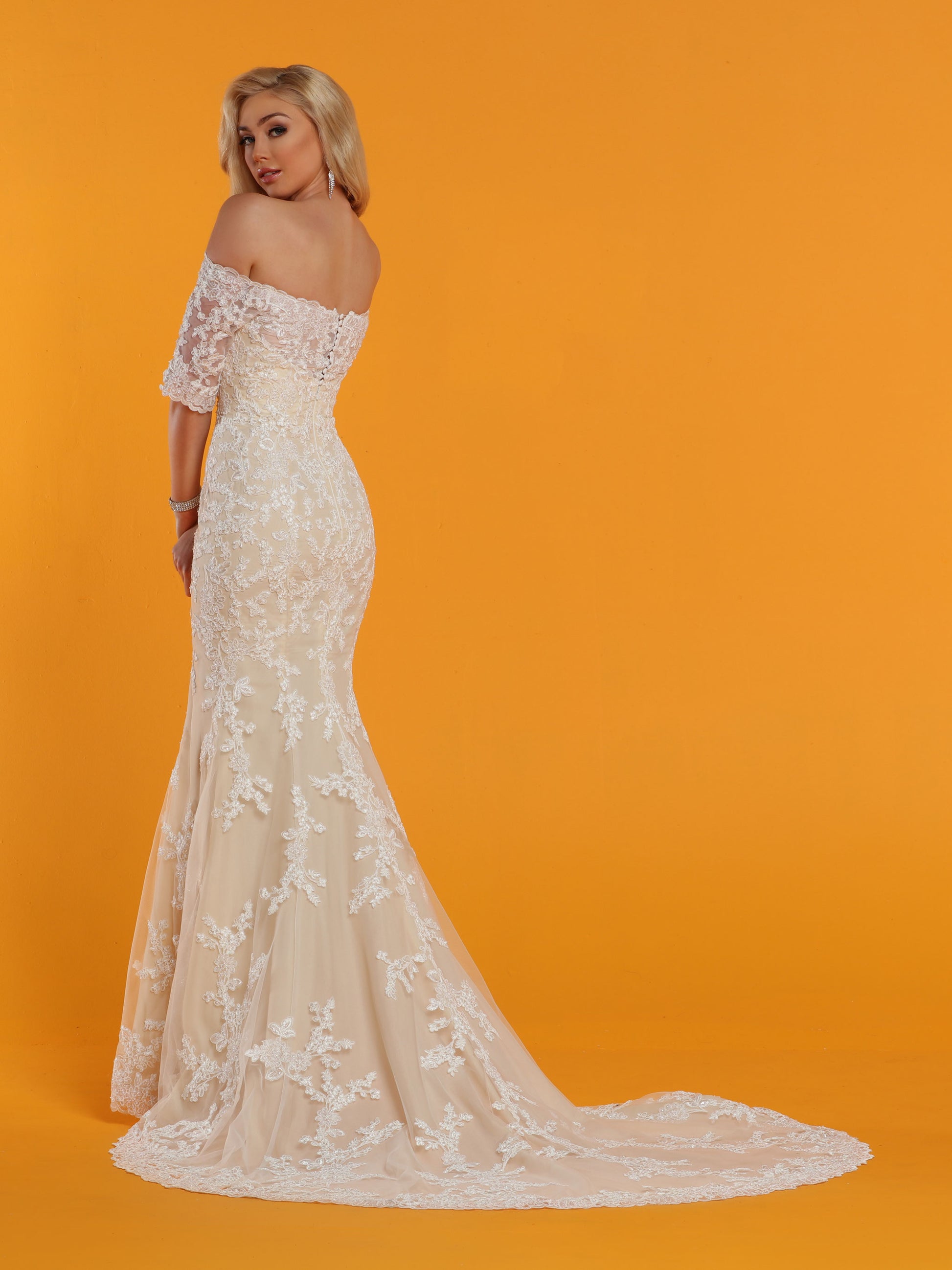 Davinci Bridal 50529 is a long Fitted Mermaid Silhouette wedding dress. Featuring an Illusion sweetheart neckline with sheer lace straight off the shoulder 1/2 sleeves. The back also features a sheer lace backing. Lace Clustered along the bodice and begins to break up as it cascades down into the skirt. Lace edge hem and train.  Available for 1-2 Week Delivery!!!  Available Sizes: 2,4,6,8,10,12,14,16,18,20  Available Colors: Ivory/Nude, Ivory/Ivory