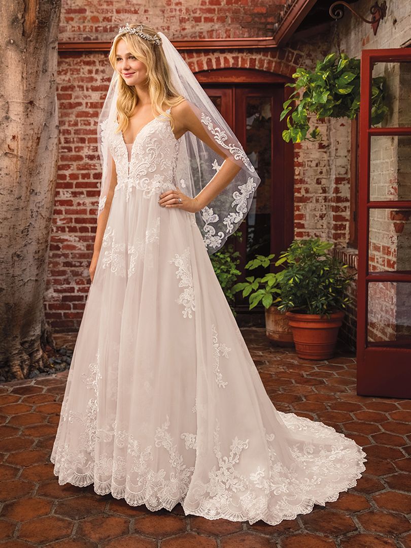 Casablanca Beloved STYLE BL286 DELILAH Other-worldly grace surrounds Delilah, swimming in sateen satin and tulle. Lace appliques cover the bodice and cascade down the flowing skirt of this bohemian wedding gown from Beloved by Casablanca Bridal. Spaghetti straps and a plunging neckline add a seductive touch, transitioning into an alluring illusion lace back. Subtle silver beading catches the light, while a matching veil finishes off this modern boho gown with a glimmer!