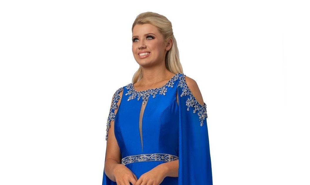 Johnathan Kayne 2075 is a Cape Prom Dress, Pageant Gown & Formal Evening Wear. This 4 way stretch Lycra gown features an Embellished illusion plunging high neckline. Embellished Over Cape Features Shoulder cutouts with a keyhole cutout in the back. skirt features a slit.