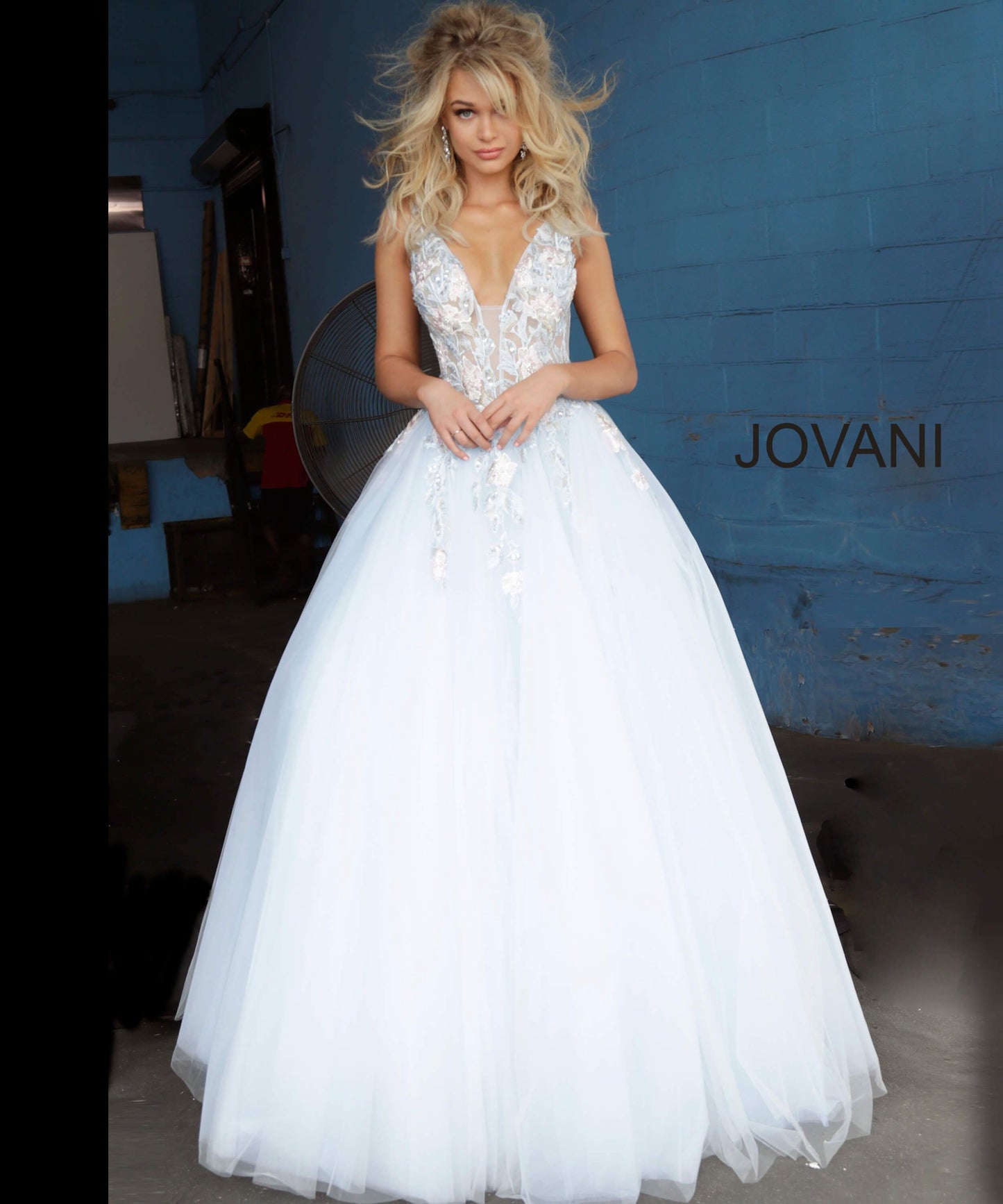 Jovani 11092 floral embellished plunging neckline tulle prom dress ball gown evening dress. Long Sheer floral lace applique embellished formal ball gown evening. Prom Dress, Pageant Gown.  Light blue tulle prom ballgown with floral embroidered bodice featuring a sheer sleeveless bodice, plunging neckline and low v-shaped back with zipper, floor-length A-line skirt. Available colors:  Blush, Light Blue