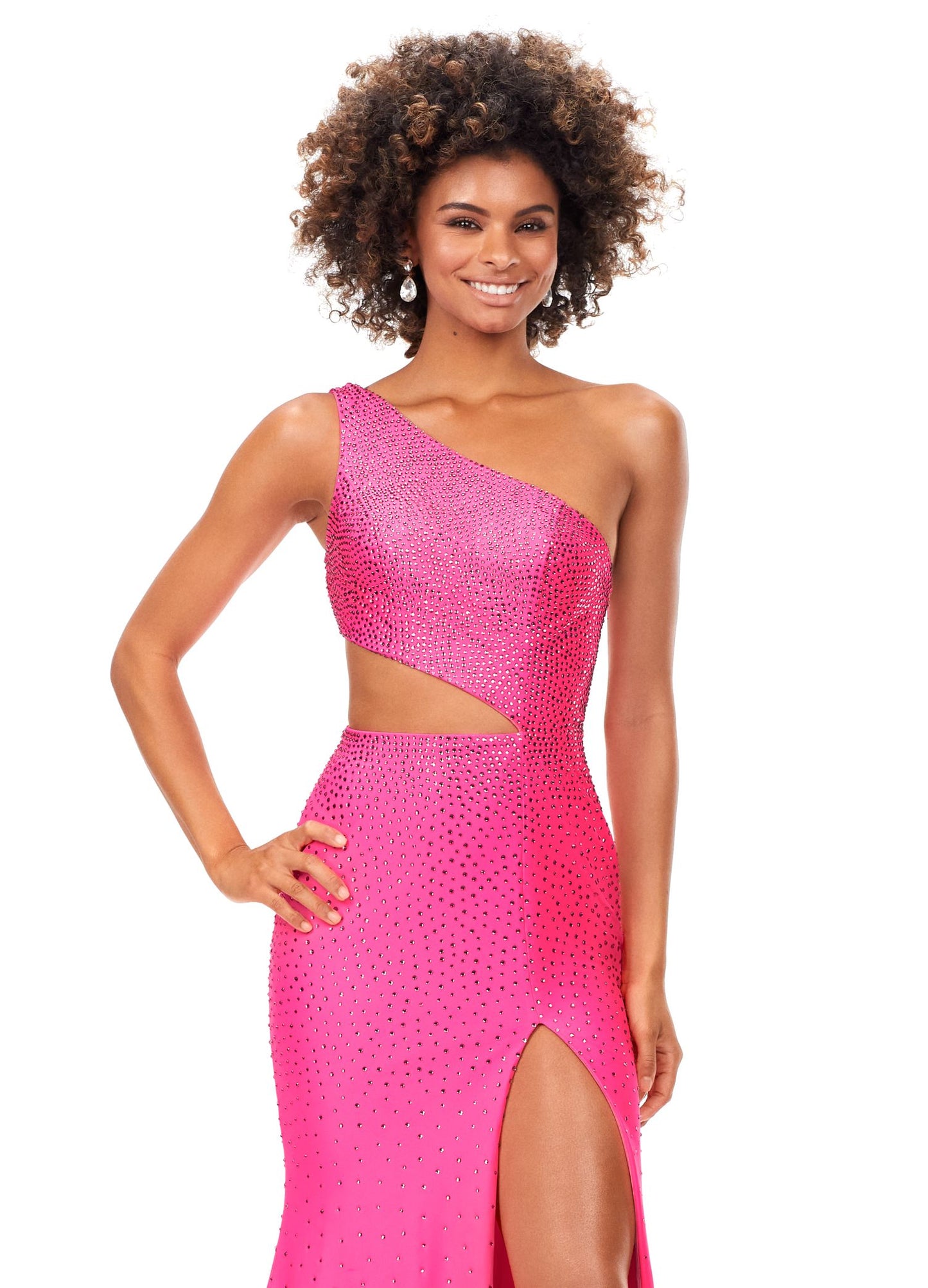 Ashley Lauren 11337 Stand out in this fitted one shoulder jersey gown embellished with heat set stones. The look is complete with an asymmetrical sharkbite cut out and left leg slit. One Shoulder Cut Out Heat Set Stones Jersey COLORS: Hot Pink, Turquoise, Black, Red, Violet