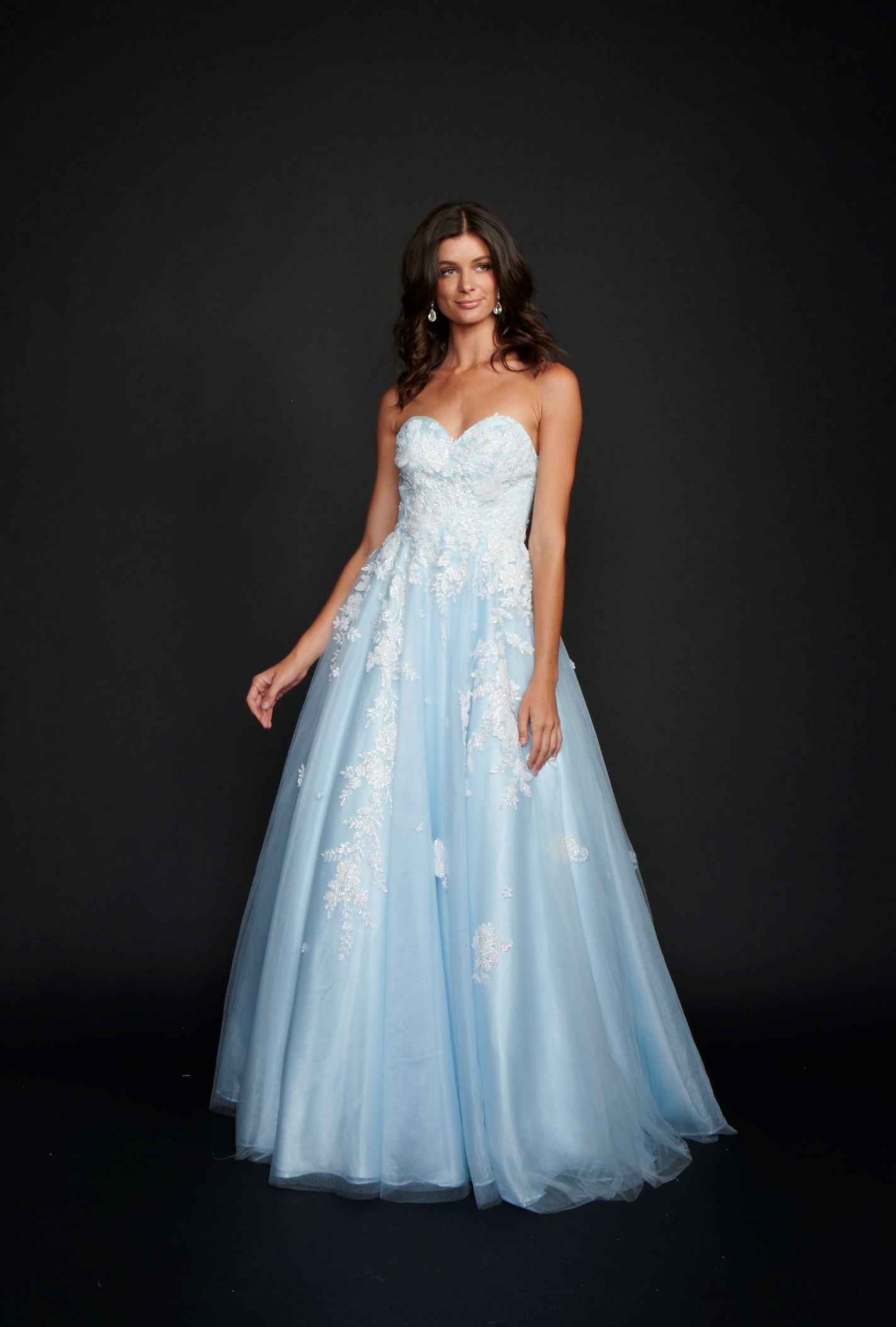 Nina Canacci 9137  This is a strapless ballgown with a sweetheart neckline and 3D floral appliques on the bodice and streaming down the dress. It is good for a Wedding dress or Prom Gown.   Available Size- 4-18  Available Color- Baby Blue, Ivory