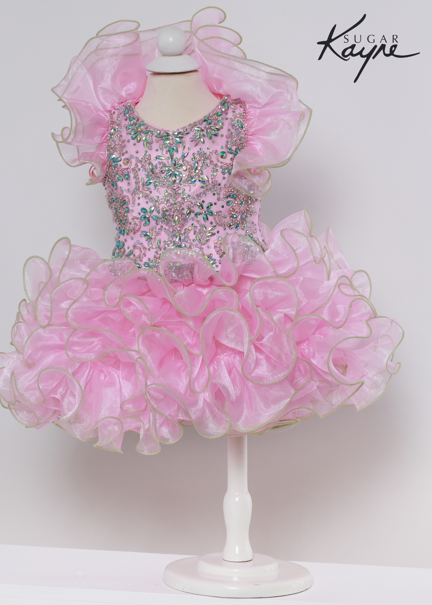 Sugar Kayne C227 Girls Baby Crystal Beaded Ruffle Sleeve Cupcake Pageant Dress Formal Have your little cupcake bring on all the charm in this stunning organza gown. The corset back is the perfect addition as the little one grows!  Colors: Baby Pink, White-Pink  Sizes: 0M, 12M, 18M, 24M, 2T, 3T, 4T, 5T, 6M, 6T  Fabric Organza, Satin Lining