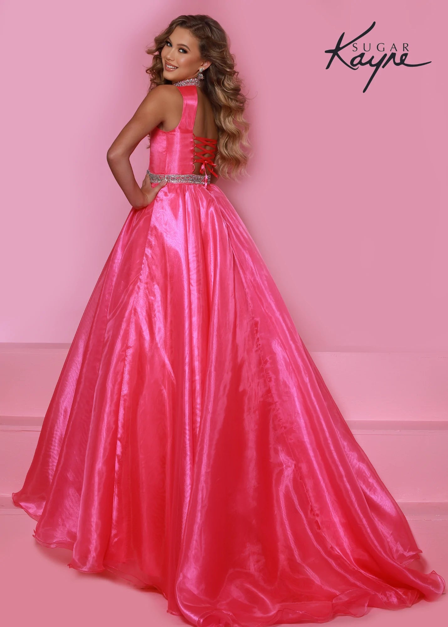 Sugar Kayne C317 Long Organza Girls A Line Pageant Dress High Neck Formal Gown Crystal Belt Simplistic but stunning! This organza ballgown features a hand-beaded collar and waist band to add a little sparkle to stun the crowd. The corset back is great as you grow! Open Back Corset  Colors: Barbie Pink, Carribbean, Ruby Red, Tangerine  Sizes: 2, 4, 6, 8, 10, 12, 14, 16  Fabric Organza, Satin Lining