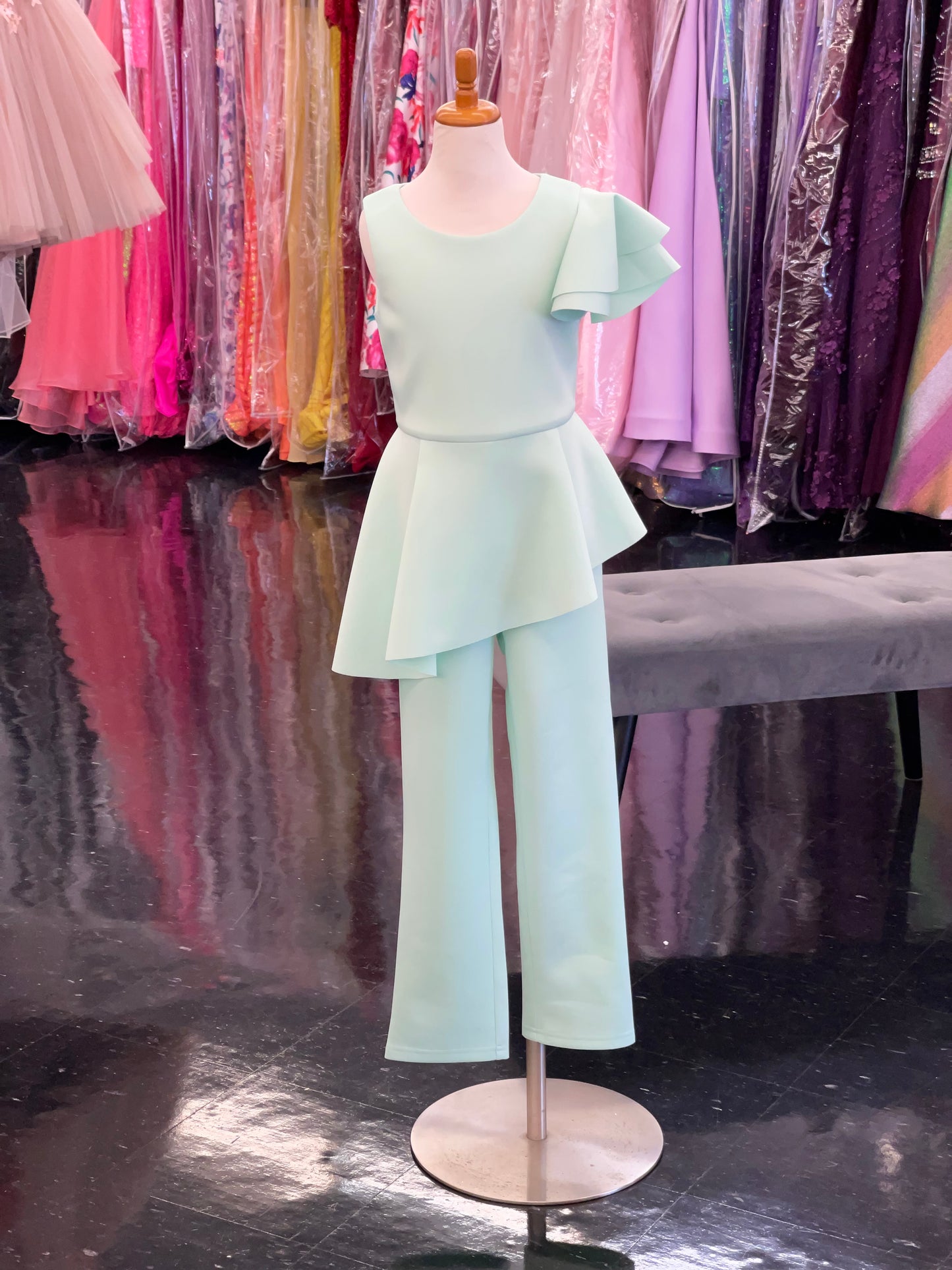 Marc Defang 8117k girls, kids pageant interview jumpsuit peplum skirt with one shoulder ruffle  Available sizes: 2-14  Available colors: Mint, Hot Pink, Red, Lilac (Check swatches for custom colors - 30-45 days)