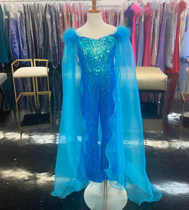 Marc Defang 8099K is a KIDS long pageant formal wear jumpsuit that is made of sequins and has off the shoulder straps.  The straps are attached to a cape with feathers at the shoulders.  Wow the crowd at your next pageant.  Available colors:  Pink, Turquoise, White, Black, Royal  Available sizes:  4,5,6,7,8,9,10,11,12,13,14   Please allow 30 Days for Delivery or a rush fee is available!