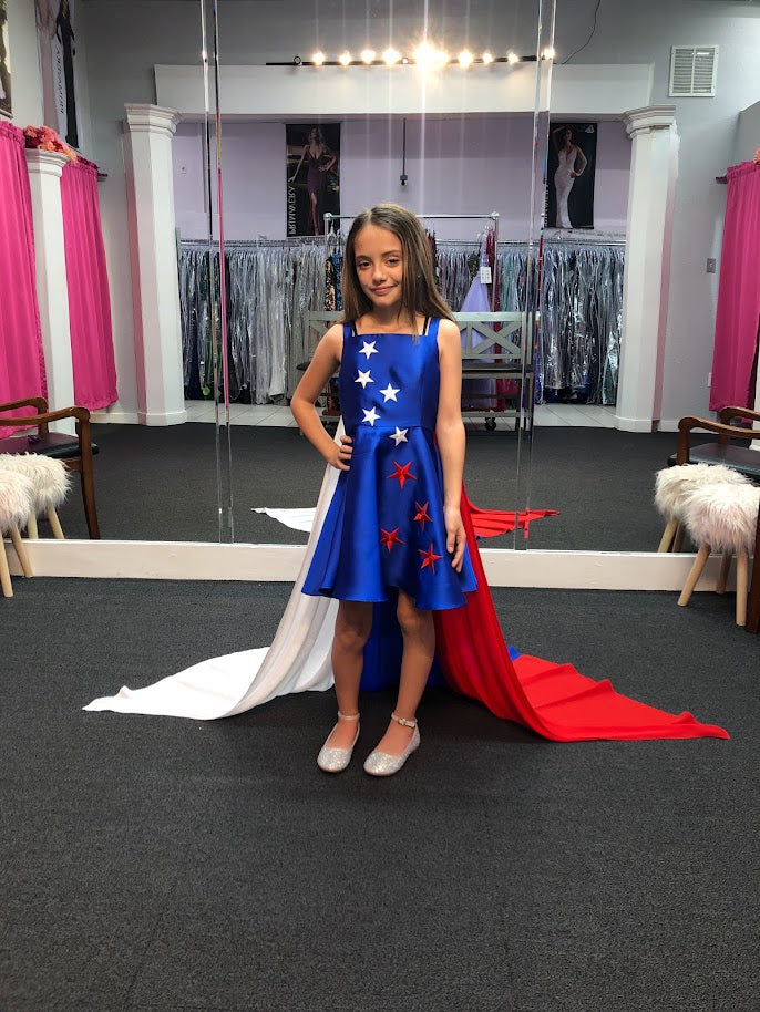 Marc Defang 5030 Red White & Blue Girls Pageant Fun Fashion Cape Detachable chiffon skirt/cape. Stars adorn he short a line dress. Perfect for Fun Fashion!  Available Sizes: 4-14  Colors: Red/White/Blue