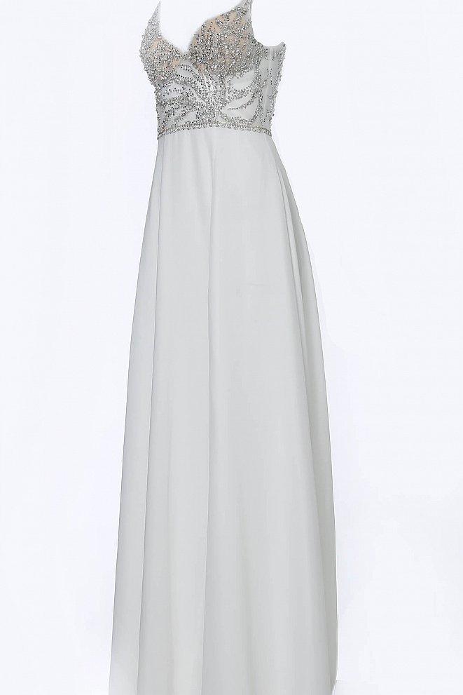 JVN4410 JVN 4410 is a long flowy pageant gown prom dress. Featuring a sheer embellished bodice and open back with with a V neckline and spaghetti straps. Flowing chiffon skirt with slit evening gown. 