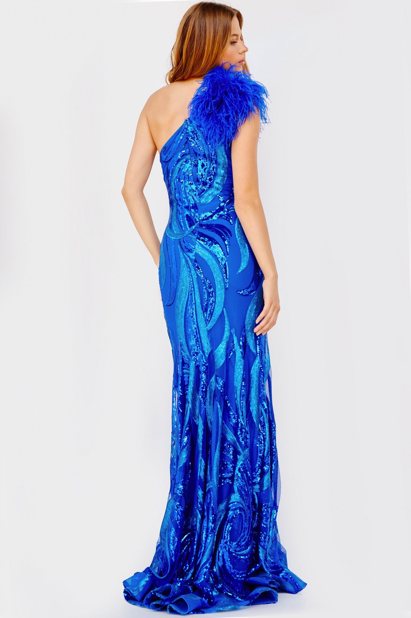 Jovani 32596 This exquisite prom dress features form-fitting sequin embellishments, a floor-length skirt with a sweeping train, and a one-shoulder feather strap for a dazzling look.