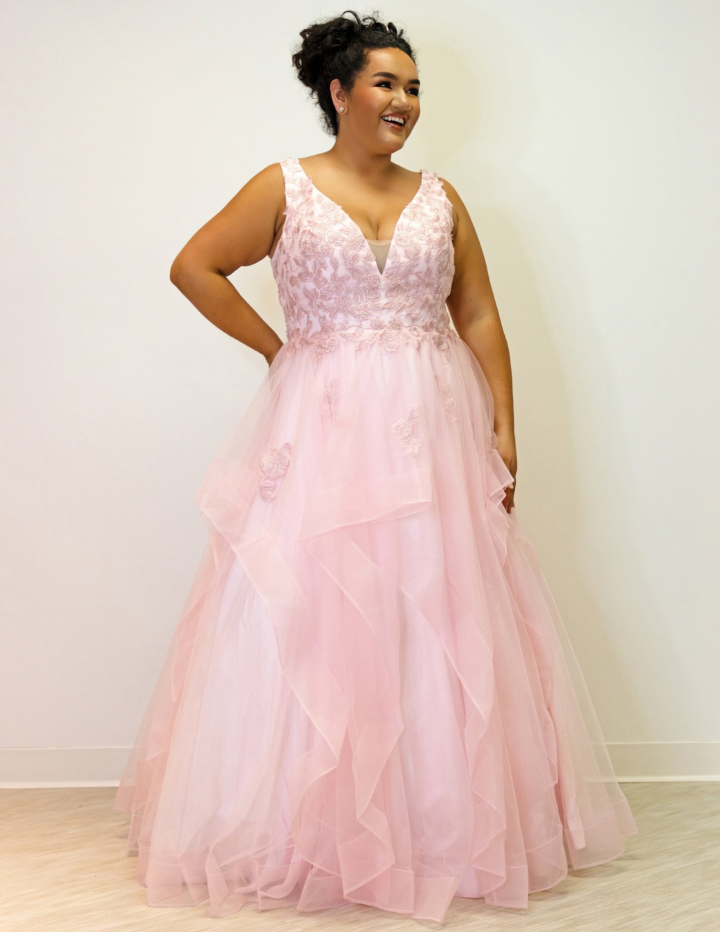 For a lasting impression at prom, the Sydney's Closet SC7347 Floral Lace Bodice dress offers timeless elegance with its layered tulle ballgown skirt and tonal mesh insert. The V-neckline and bra-friendly straps deliver a flattering fit, while the natural waistline and horsehair hem ensure a stylish finish.