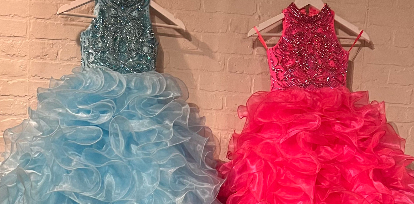 The elegant and sophisticated Sugar Kayne C328 Girls Preteens Pageant Dress boasts a dazzling halter neckline and full ruffle ball gown skirt with a crystal bodice, perfect for making a memorable fashion statement.  Colors: Barbie Pink, Cinderella Blue, Yellow