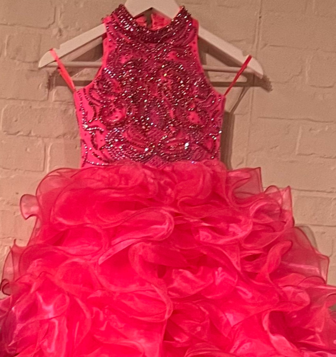 The elegant and sophisticated Sugar Kayne C328 Girls Preteens Pageant Dress boasts a dazzling halter neckline and full ruffle ball gown skirt with a crystal bodice, perfect for making a memorable fashion statement.  Colors: Barbie Pink, Cinderella Blue, Yellow