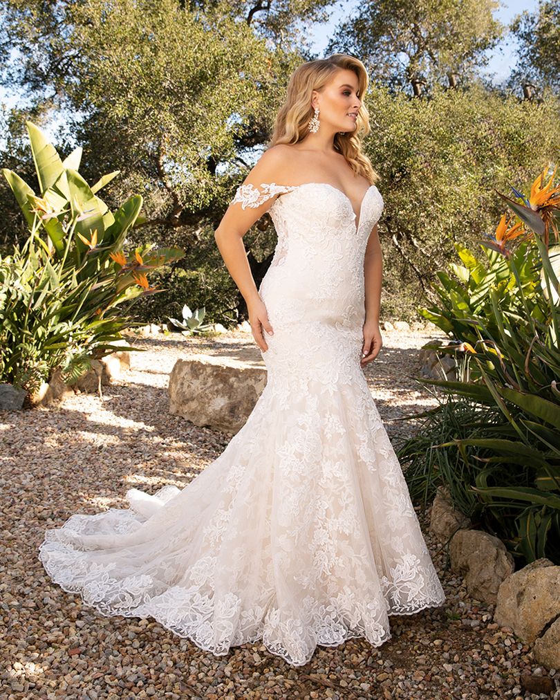 Style 2376 KARINA by Casablanca Bridal is a glamorous twist on the classic lace wedding dress. Off-shoulder sleeves transition into a classic sweetheart neckline, while floral lace swirls all throughout the fit-and-flare silhouette. The illusion back, lined with a row of subtle crystal buttons, transitions flawlessly into a gently scalloped train. A matching, two-tier cathedral length veil is available for the bride who wants to make an extra remarkable impact.  Size: 10, 14, 20  Ivory/Nude/Ivory/Silver