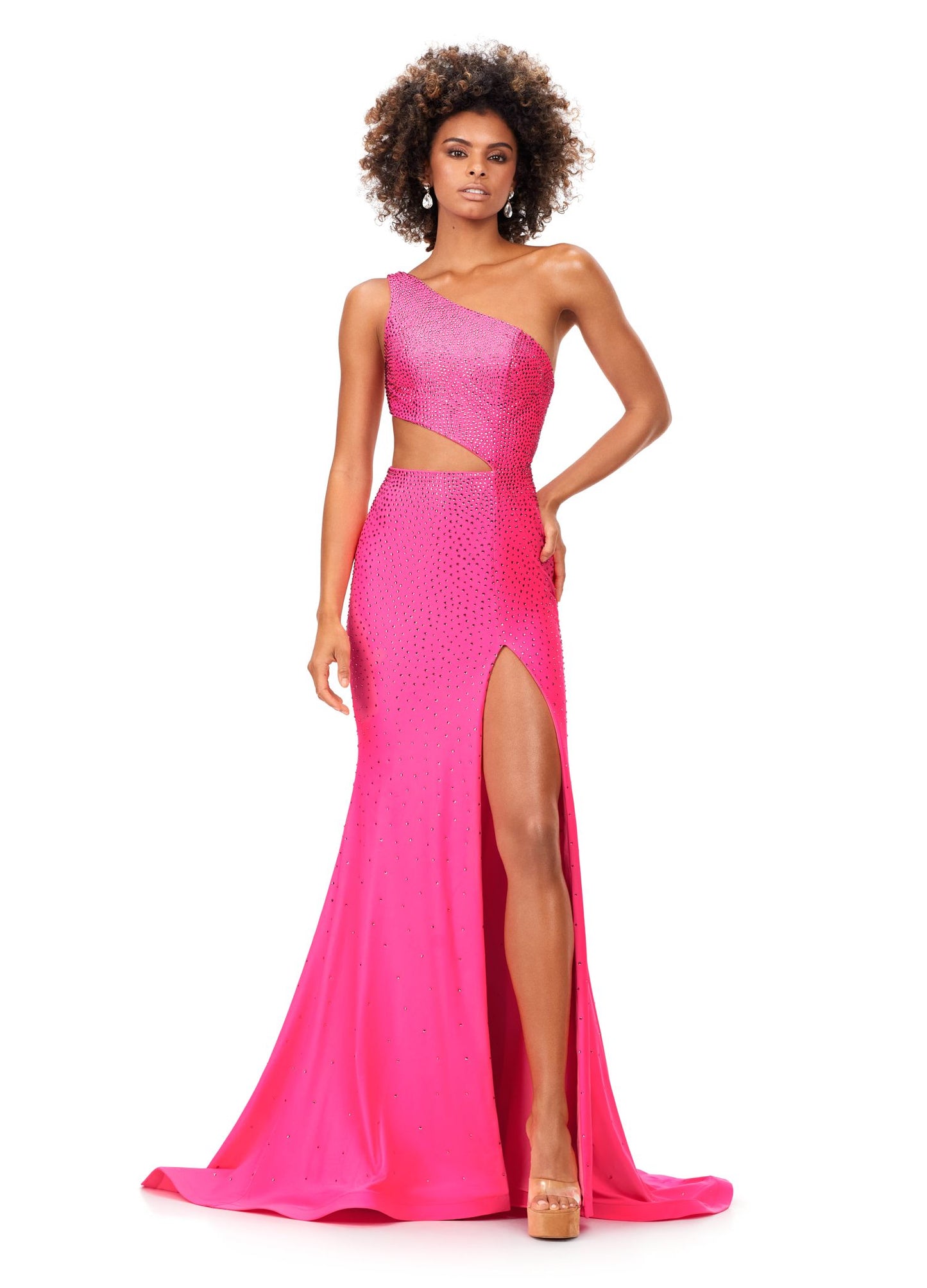 Ashley Lauren 11337 Stand out in this fitted one shoulder jersey gown embellished with heat set stones. The look is complete with an asymmetrical sharkbite cut out and left leg slit. One Shoulder Cut Out Heat Set Stones Jersey COLORS: Hot Pink, Turquoise, Black, Red, Violet