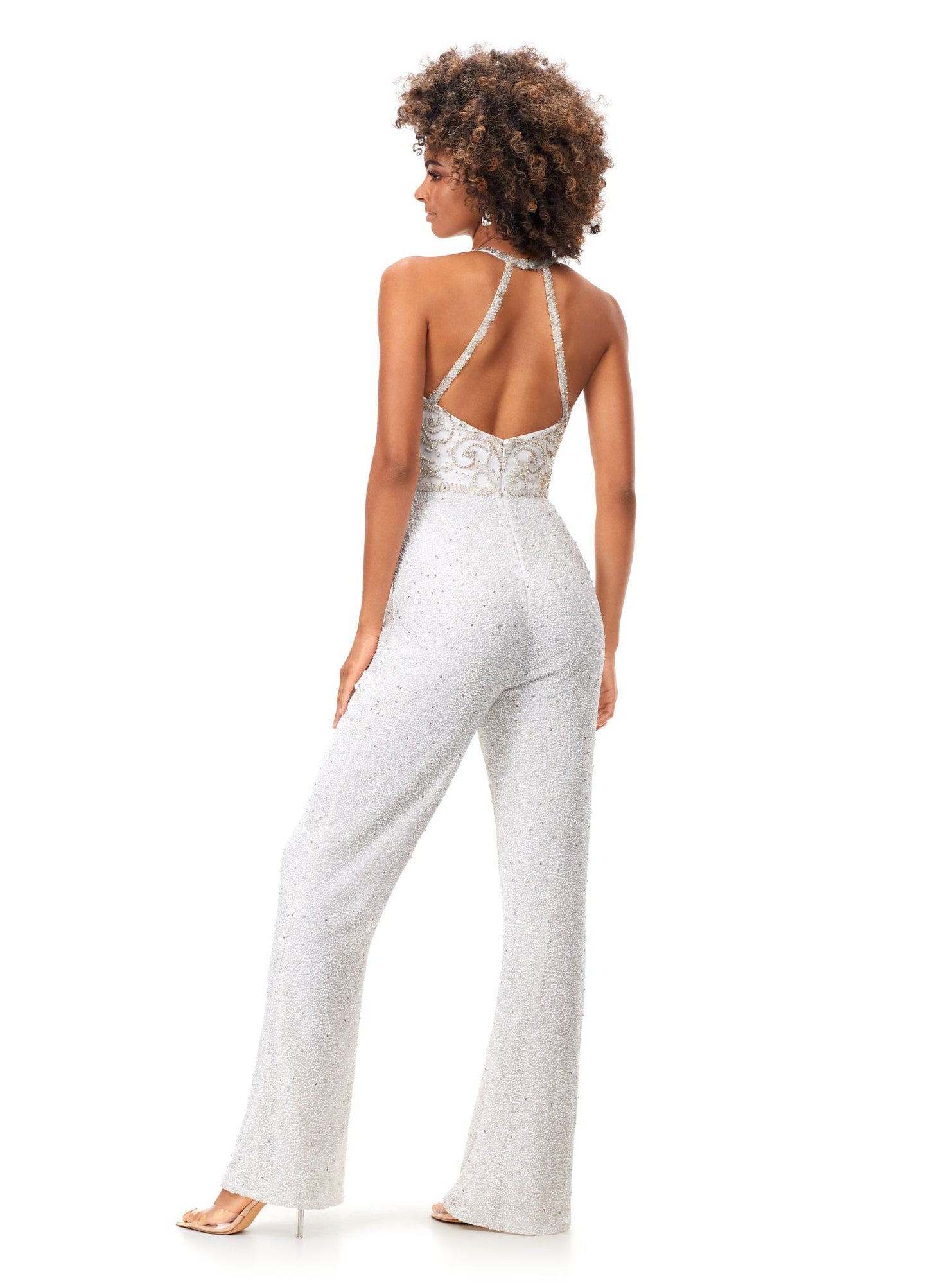 Ashley Lauren 11339 This unique halter style jumpsuit features an intricately beaded bodice, open back and wide leg pants. Halter Neckline Open Back Wide Leg Pants Fully Hand Beaded COLORS: Black, Ivory, Lilac