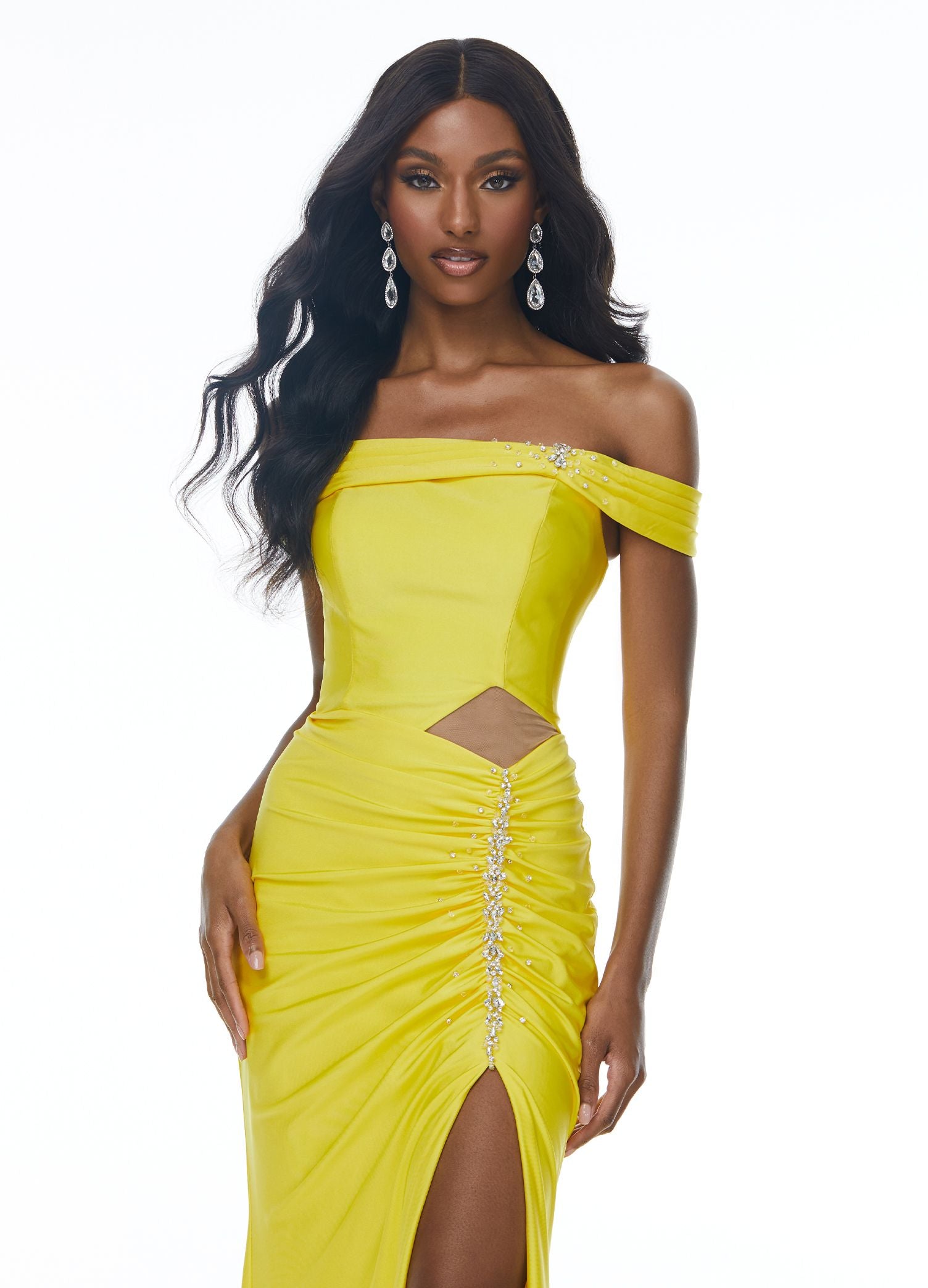 Ashley Lauren 11031 This jersey prom dress has a ruching along the off shoulder straps and waistline, crystal detailing, a modern cut out and lace up back. The skirt on this long pageant evening gown is complete with a left leg slit.  Colors  Yellow, Royal  Sizes  0, 2, 4, 6, 8, 10, 12, 14, 16  Off Shoulder Cut Out Slit Lace up Back